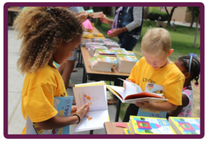 two toddlers enjoying their books during the FESTIVAL OF TALES